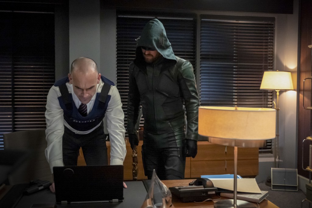 Quentin Lance (Paul Blackthorne) et Green Arrow (Stephen Amell) regardent l'écran d'un ordinateur